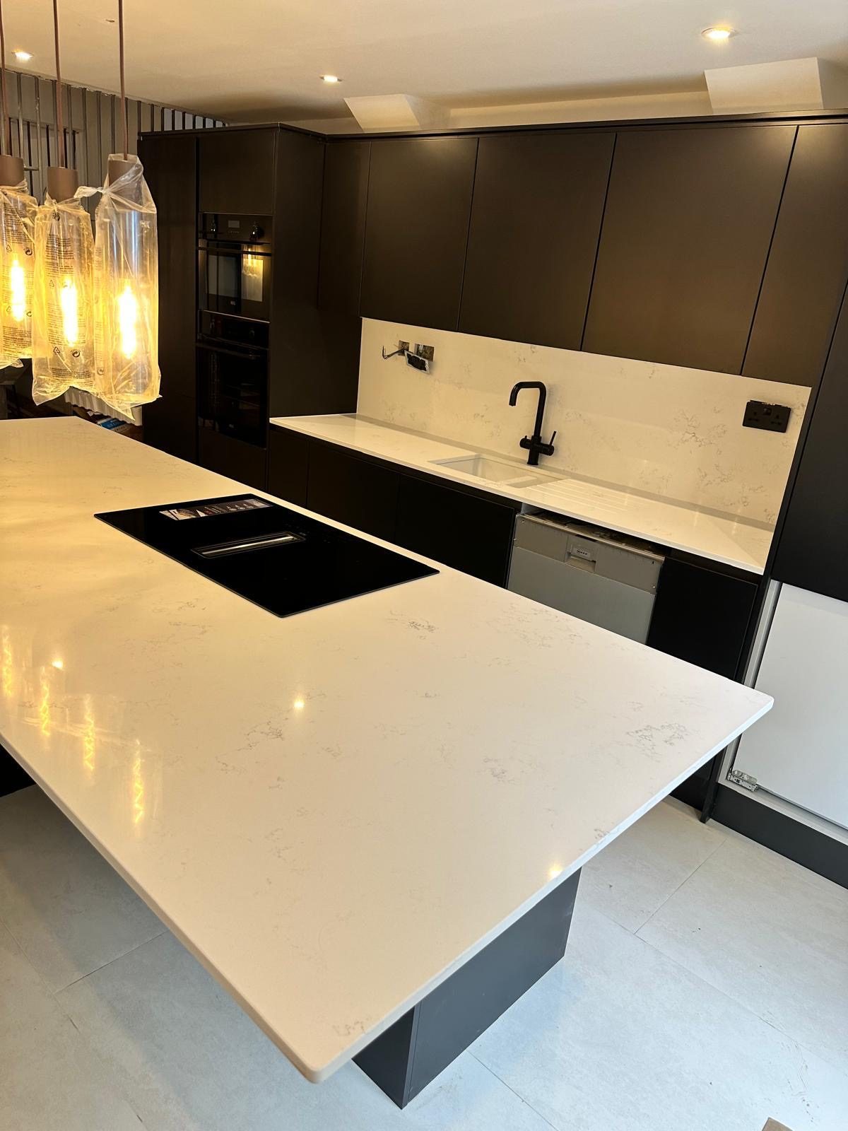 Modern white quartz kitchen island installed by Levant